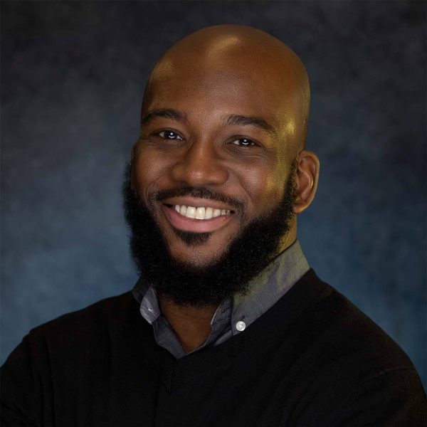 Black male professional headshot smiling